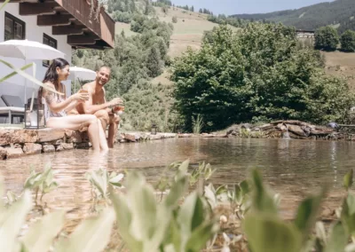 Entspannen am Naturbadeteich, nach dem Wandern die Auszeit genießen, Sommerurlaub in den Bergen, die Seele baumeln lassen, Wellnesshotel Saalbach